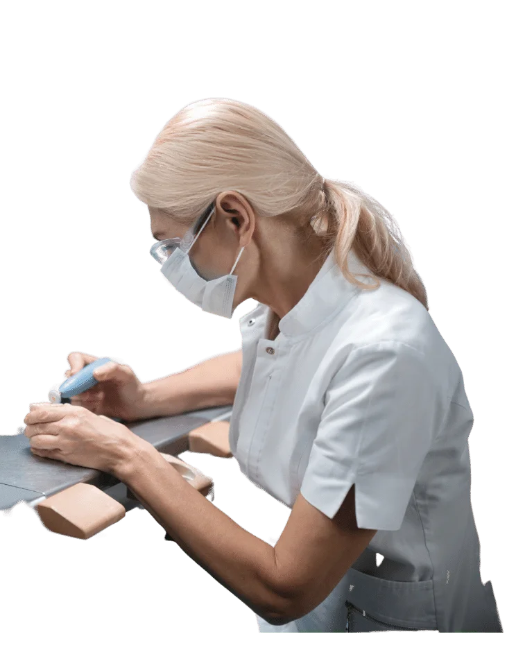Prosthodontist in a lab coat and mask working on a piece of paper